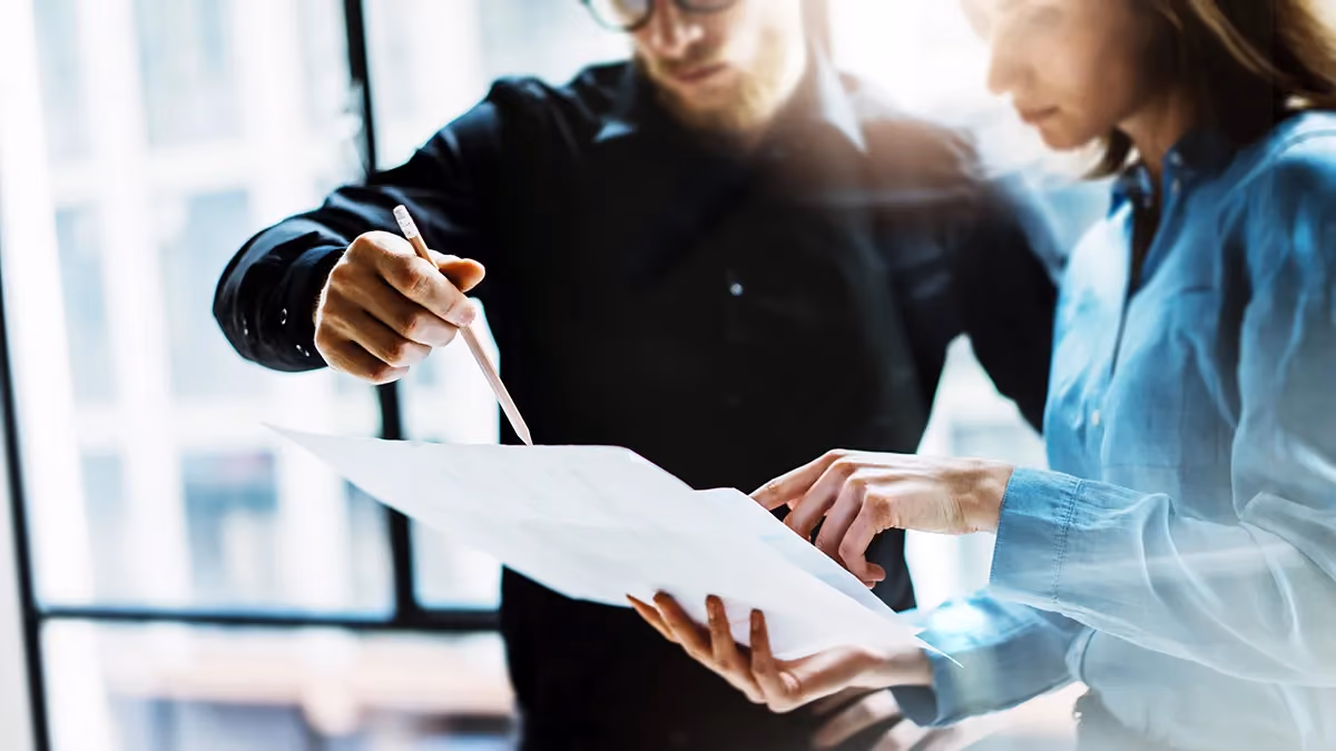 Two colleagues check paperwork