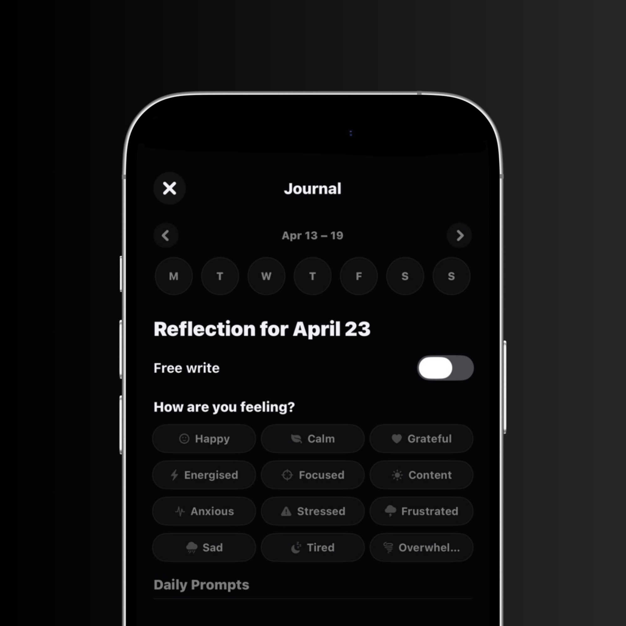 Mobile phone screen displaying a journal app's reflection page for April 23, showing mood options like Happy, Calm, Grateful, Energised, Focused, Content, Anxious, Stressed, Frustrated, Sad, Tired, and Overwhelmed.