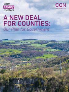 CCN document "A New Deal for Counties" featuring aerial landscape view of green countryside and forests