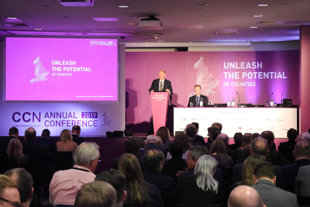 CCN Annual Conference 2019 presentation stage with speakers and audience members in auditorium