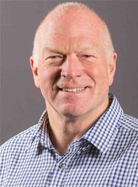 Smiling bald man in blue checkered shirt against gray background