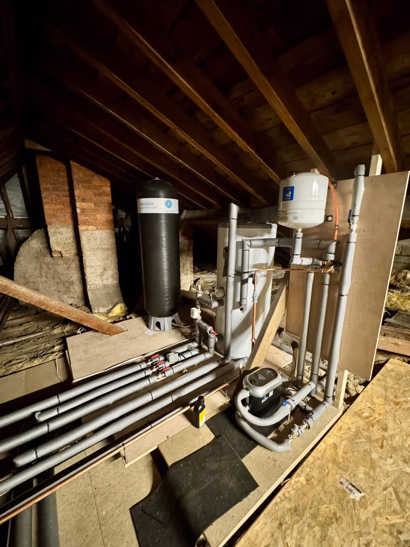 A system of pipes and tanks installed in an attic for heating or water management.