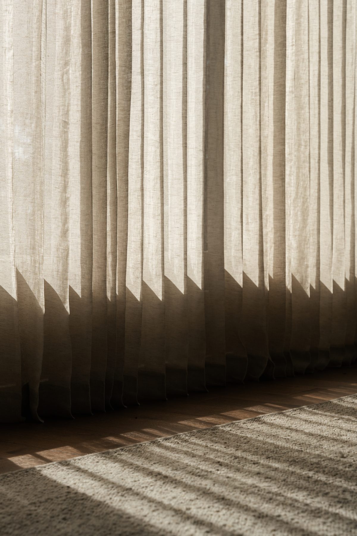 Devonshire Residence sheer linen curtains casting layered shadow patterns across the floor, light study by Jeffrey Guckert