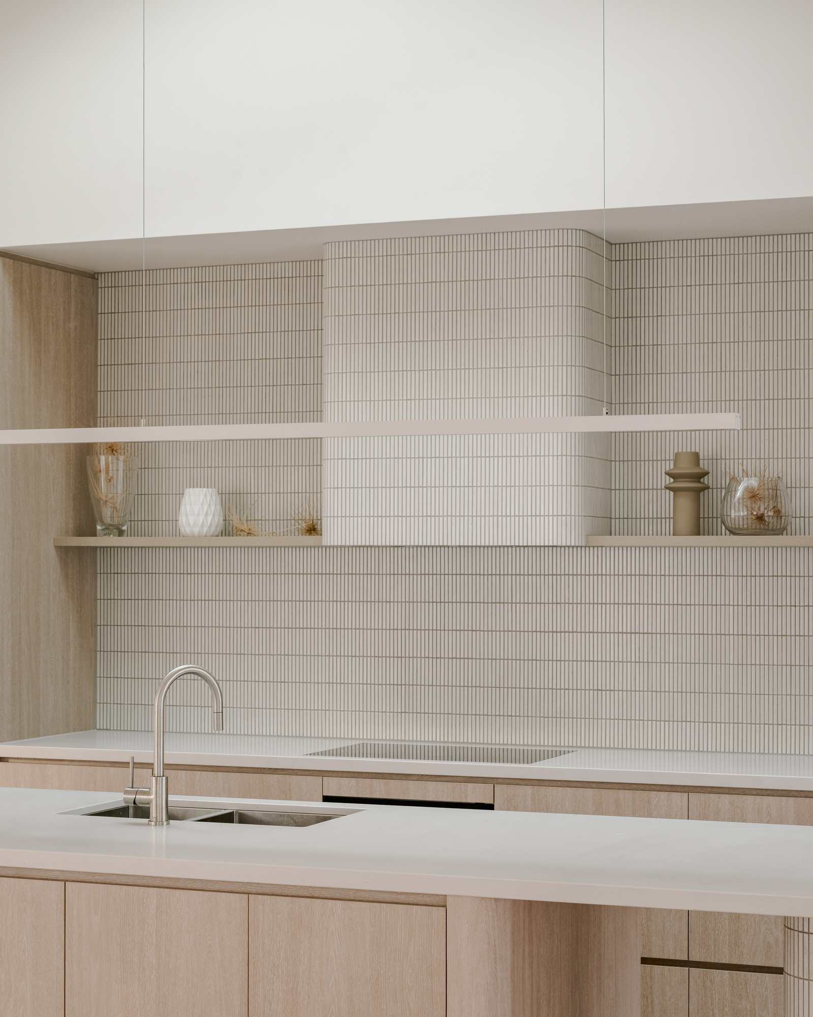 Kitchen with sculptural kit-kat tiled rangehood — Sorrento House