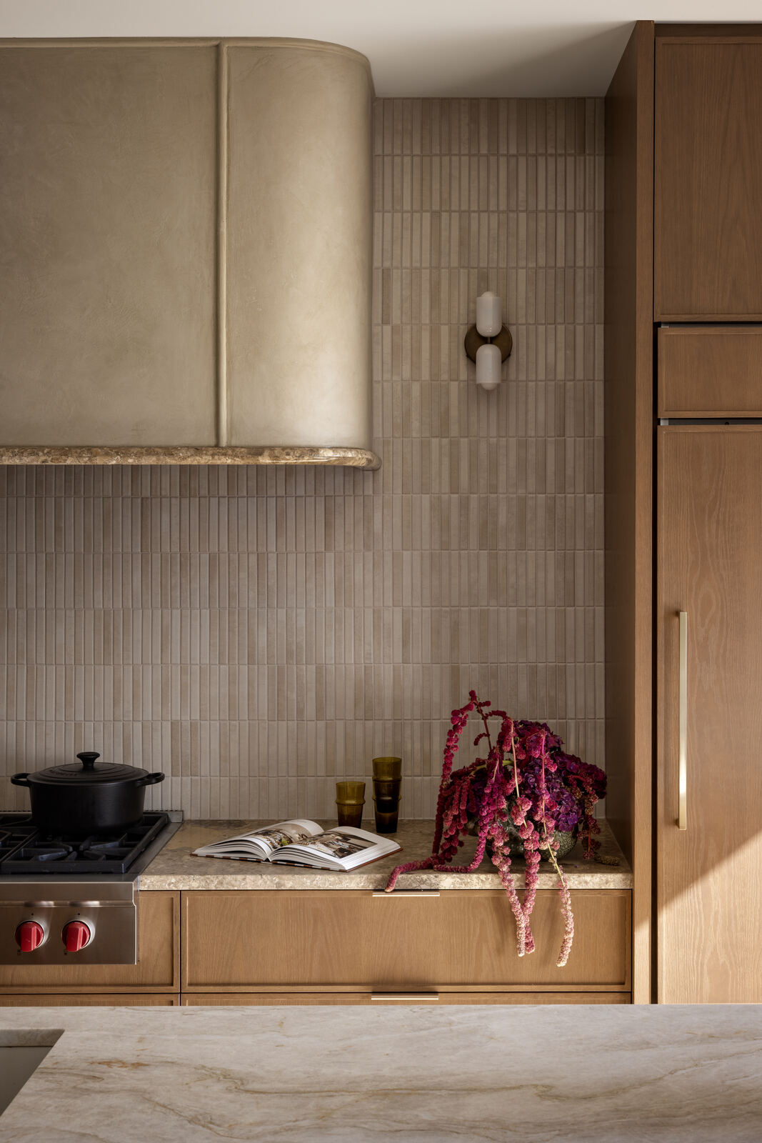 Kitchen detail with textured tile splashback, stone benchtop and oak cabinetry, Madison Residence