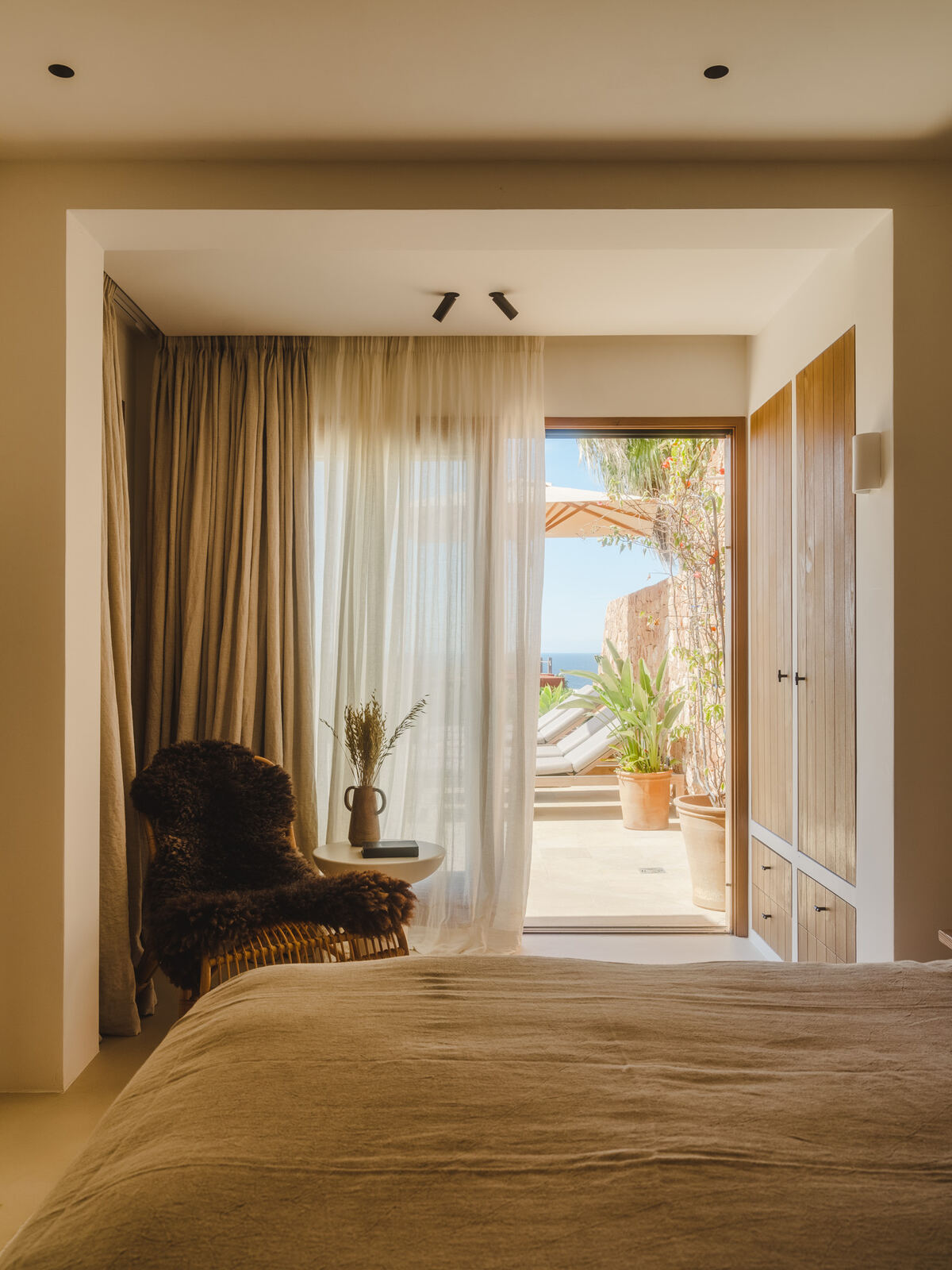 Bedroom opening to a sunlit terrace, Casa M