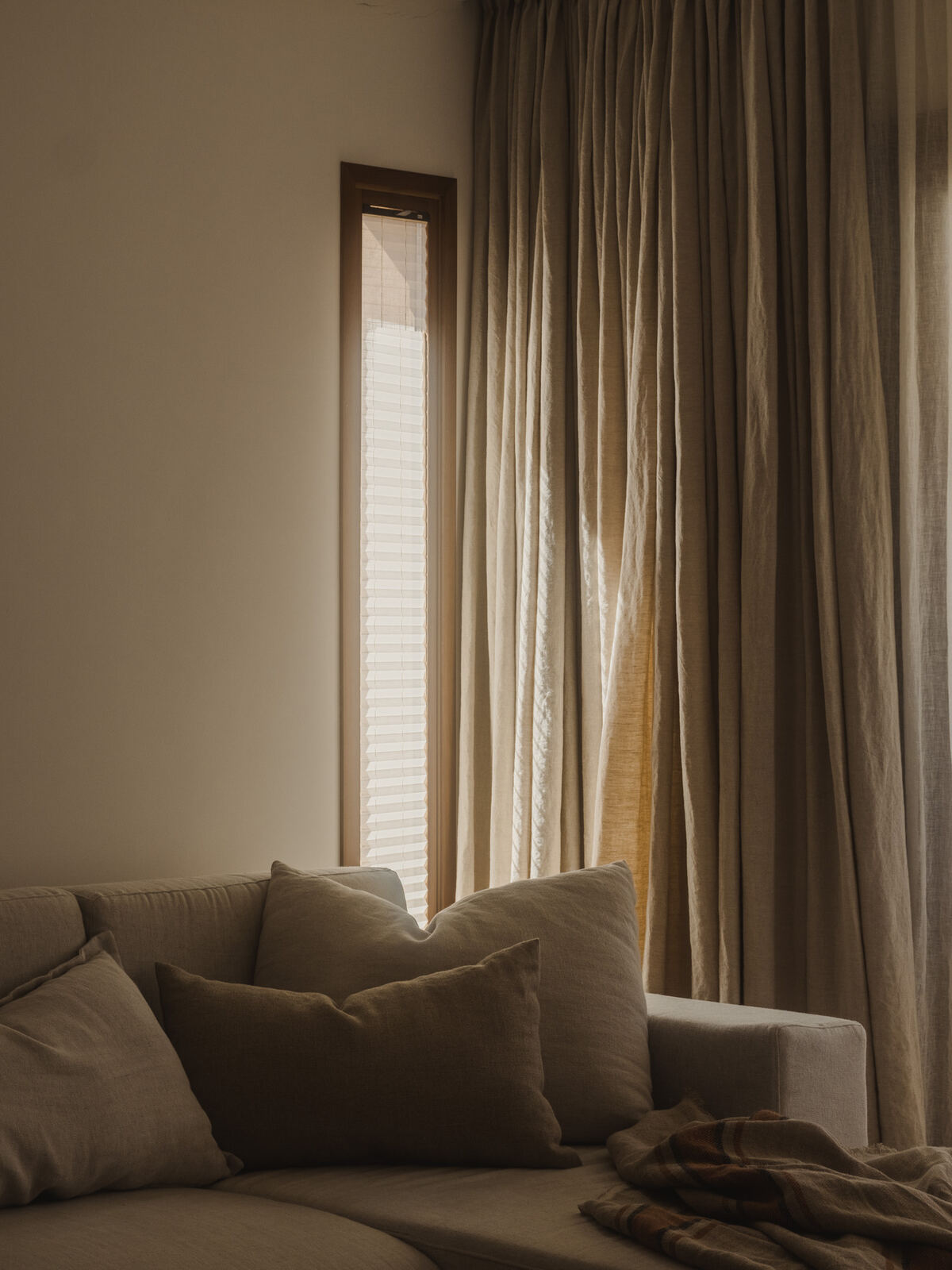 Window seat layered with natural linen cushions, Casa M