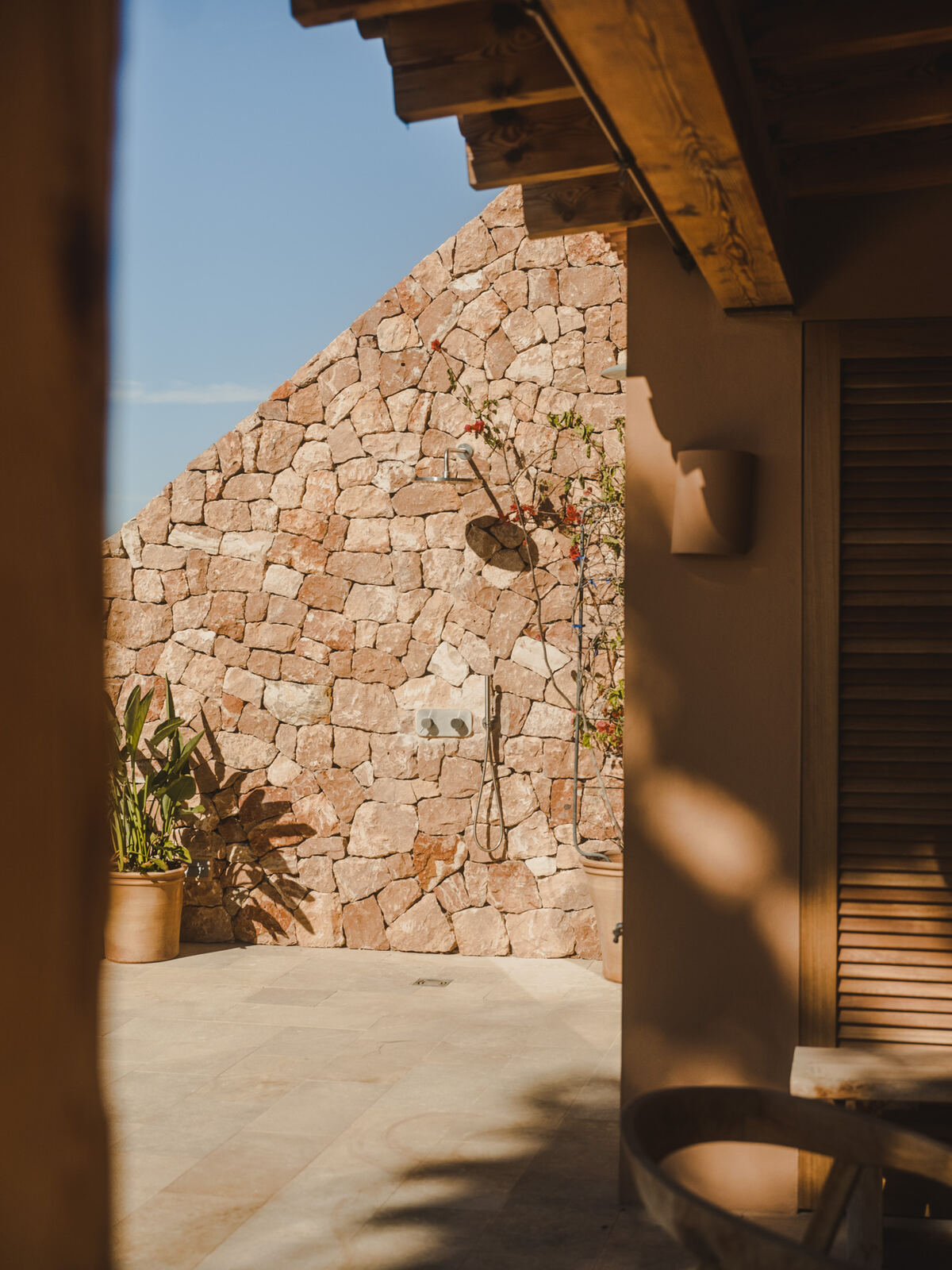 Dry stone wall and shaded courtyard at the entry, Casa M