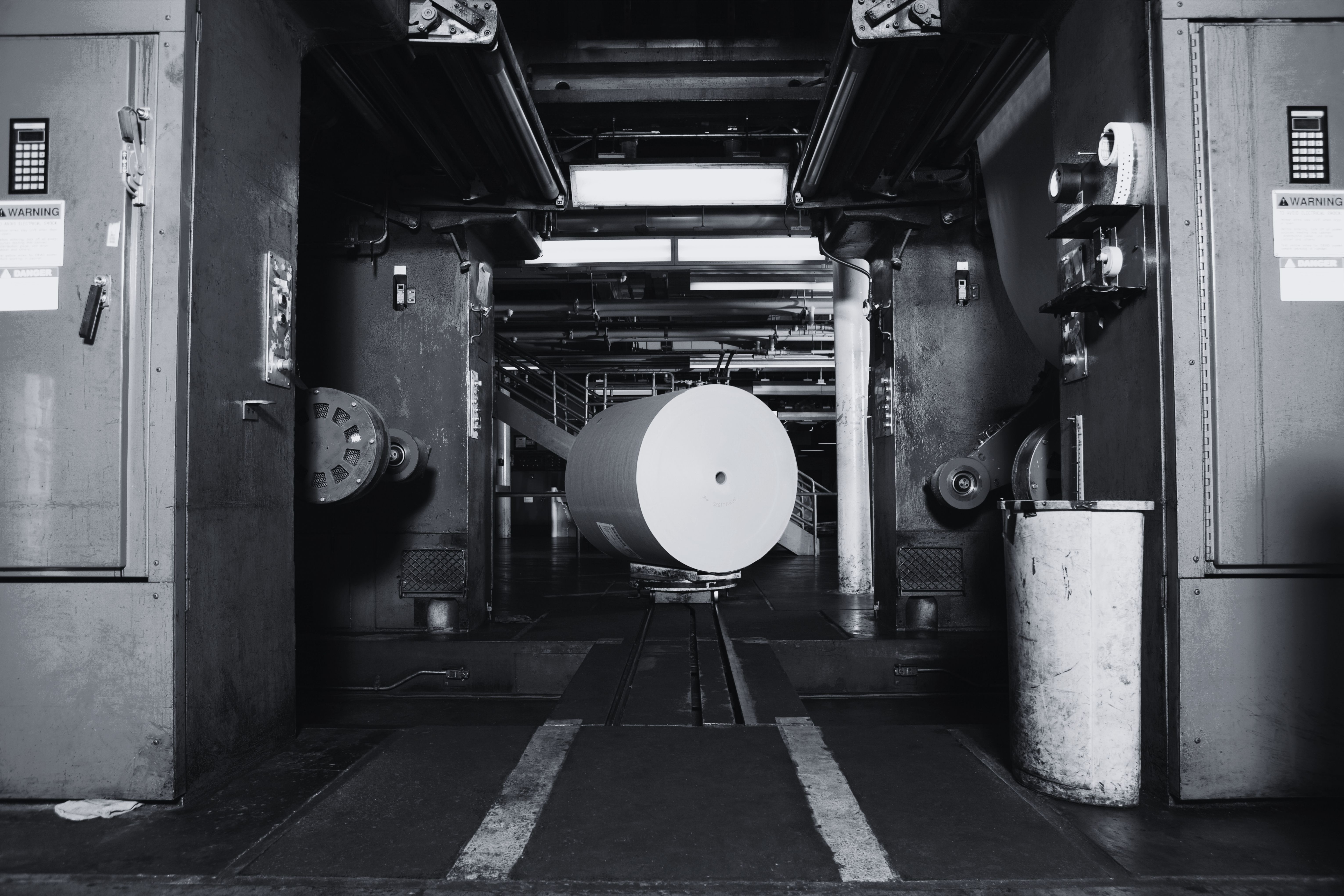 Newspaper printing press with a paper roll being prepared