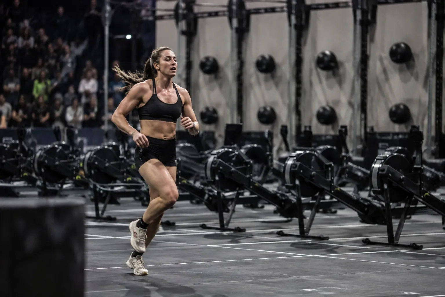 HYROX athlete running between workout stations in a race venue