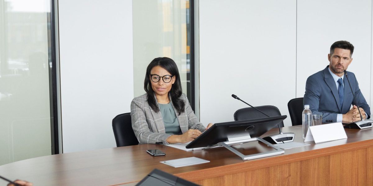 A team in a meeting appears to be in deep discussion or disagreement, reflecting the decision paralysis caused by a lack of trust in data.