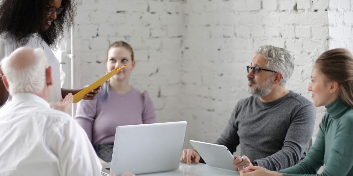 Professionals collaborating and adapting to new AI tools and methodologies in their work.