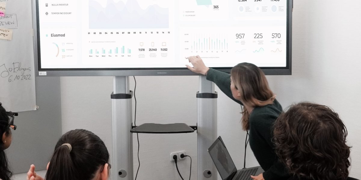 A team actively brainstorming and collaborating on cloud security strategies using a whiteboard.