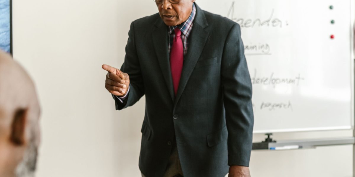 A business leader presenting to their team, emphasizing the importance of cybersecurity through example and communication.