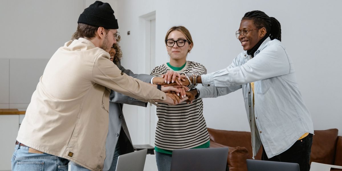 A small team working together, fostering trust and collaboration to build reliable and ethical AI systems.