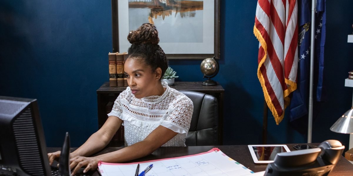 A government official meticulously reviewing compliance documents for AI technology adoption.