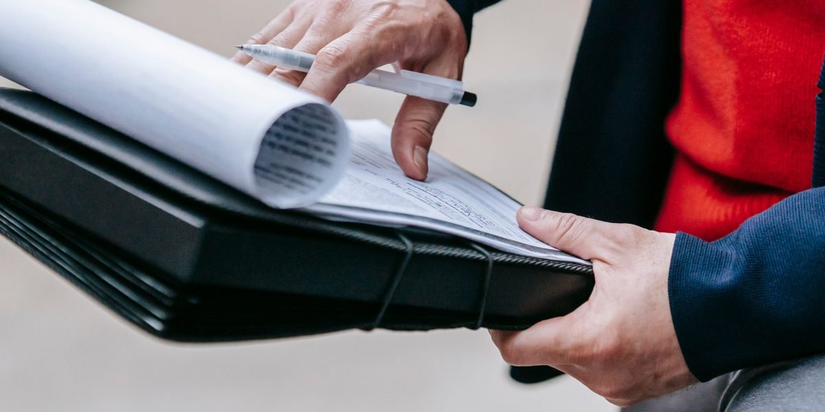 A professional meticulously reviews documents, symbolizing the critical role of ensuring data integrity and ethical practices in AI systems.