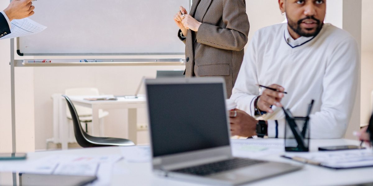 A diverse team collaborating around a large monitor, demonstrating a comprehensive approach to planning and implementing AI at an enterprise scale.