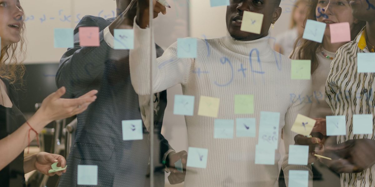 A team engaged in a design thinking session, focusing on user needs and experiences for product development.