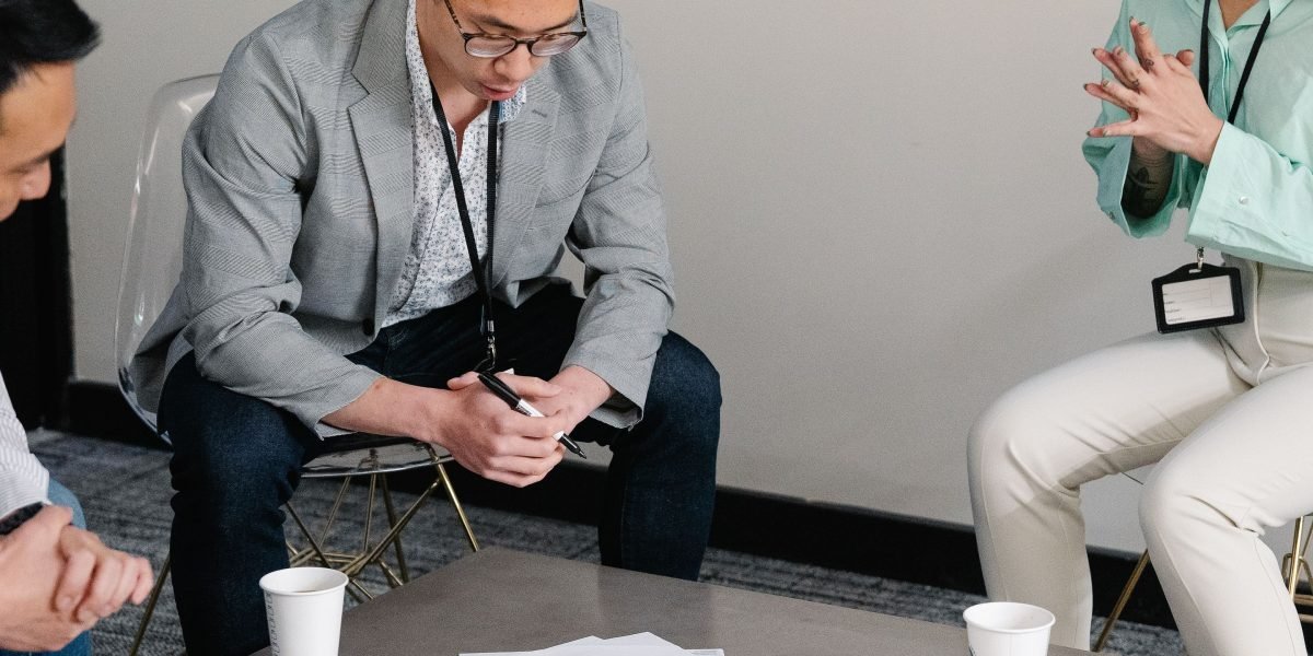 Professionals in a modern office setting discussing strategy, symbolizing the human element of building trust in AI.