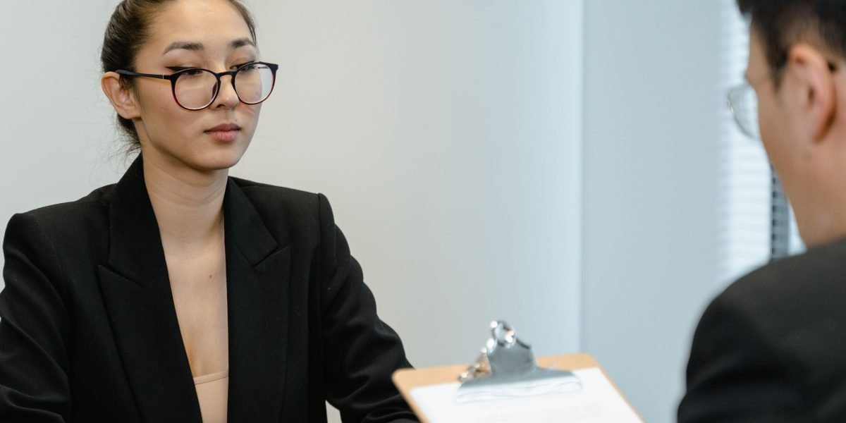 A professional conducting an interview with a candidate, representing the process of hiring for specialized AI roles.