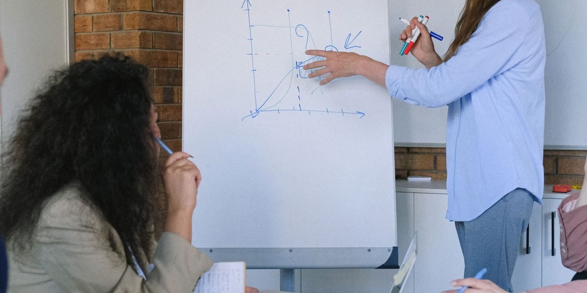 A team collaboratively analyzing complex data challenges on a whiteboard, focusing on solutions.