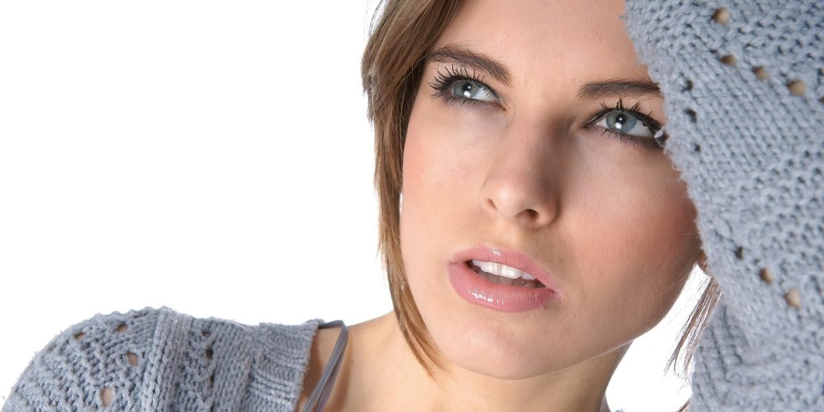 A person looking puzzled or frustrated while reviewing information, representing the confusion and challenges posed by AI detector limitations.