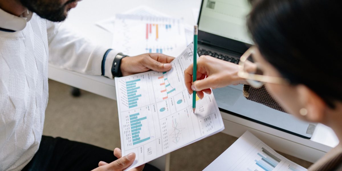 A team collaborates, meticulously reviewing complex data records and their origins.