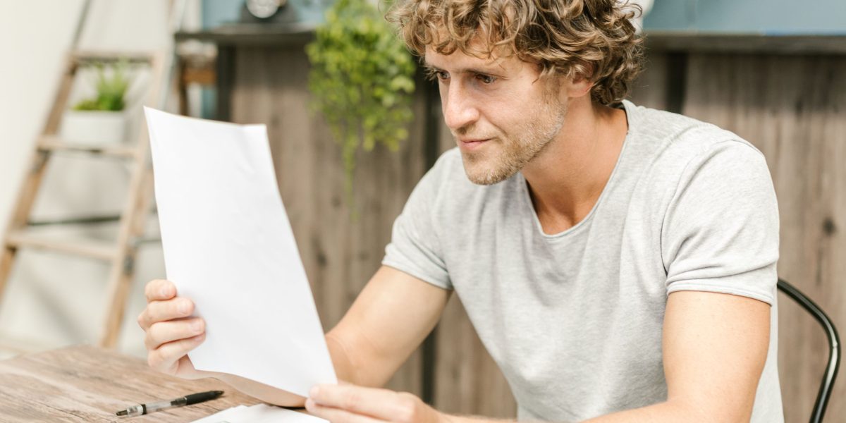 A person carefully reviewing documents related to data privacy and consent.