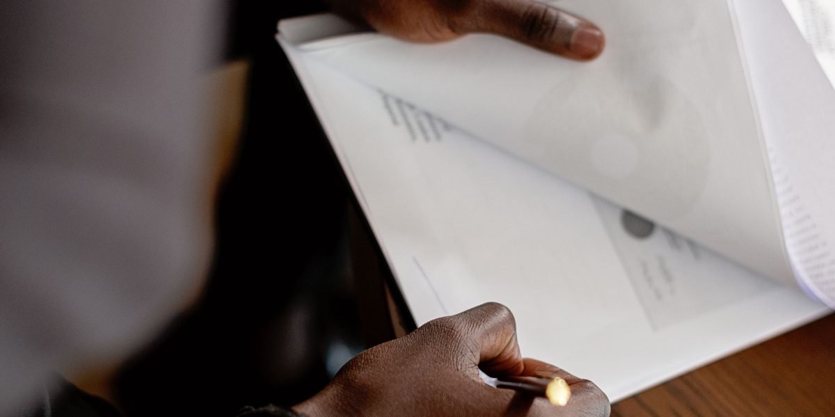 A person intently reviewing a complex data report, symbolizing the challenge of discerning truth amidst AI-driven insights.