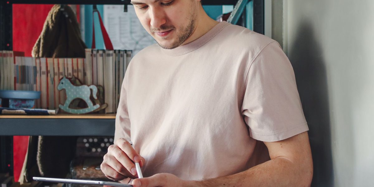 A focused individual actively using a tablet to search for career opportunities online.