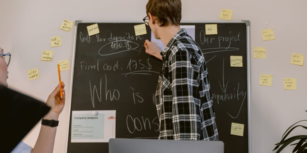A diverse team collaborating around a whiteboard, working to solve a complex data-related problem.