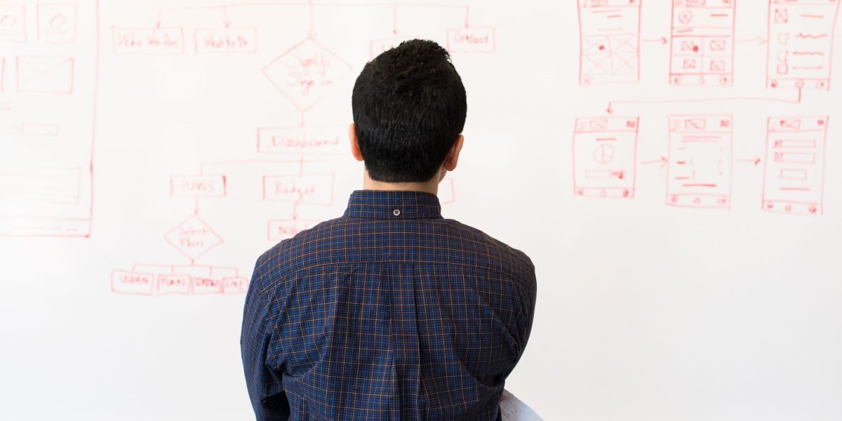A person focused and reflective, analyzing complex data on a display, representing deep thought about AI challenges.