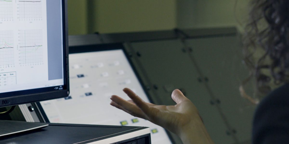 A person focused on reviewing complex datasets or reports, symbolizing the challenges in obtaining and maintaining high-quality data for AI systems.