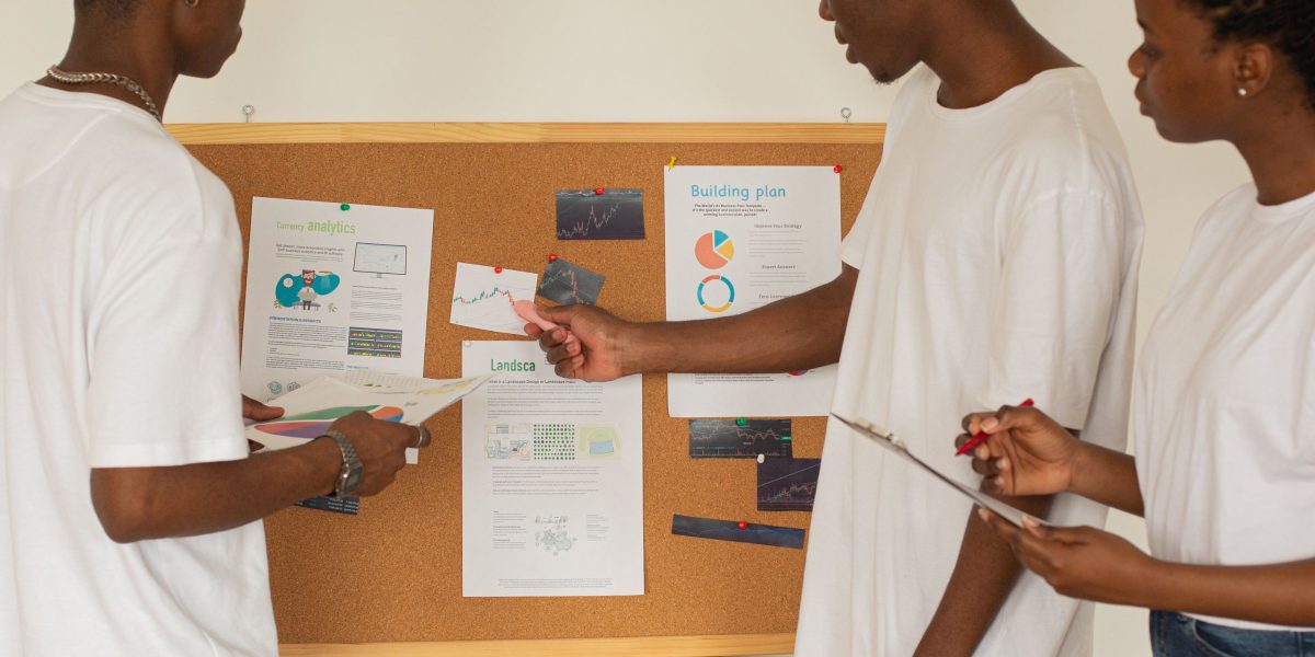 A team collaborates in a meeting room, strategically planning their organization's AI learning initiatives.