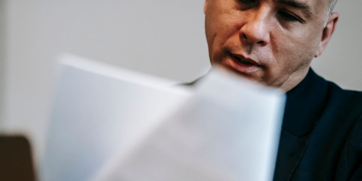 A person confidently reviews documents, symbolizing the trust built through transparent data practices in the digital age.