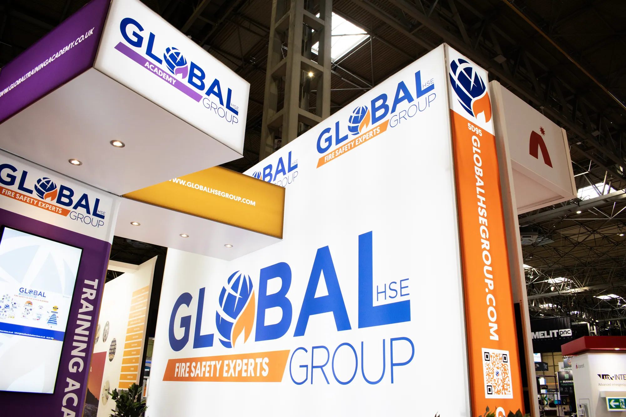 Close-up of branded lightbox towers and headers on a modular stand