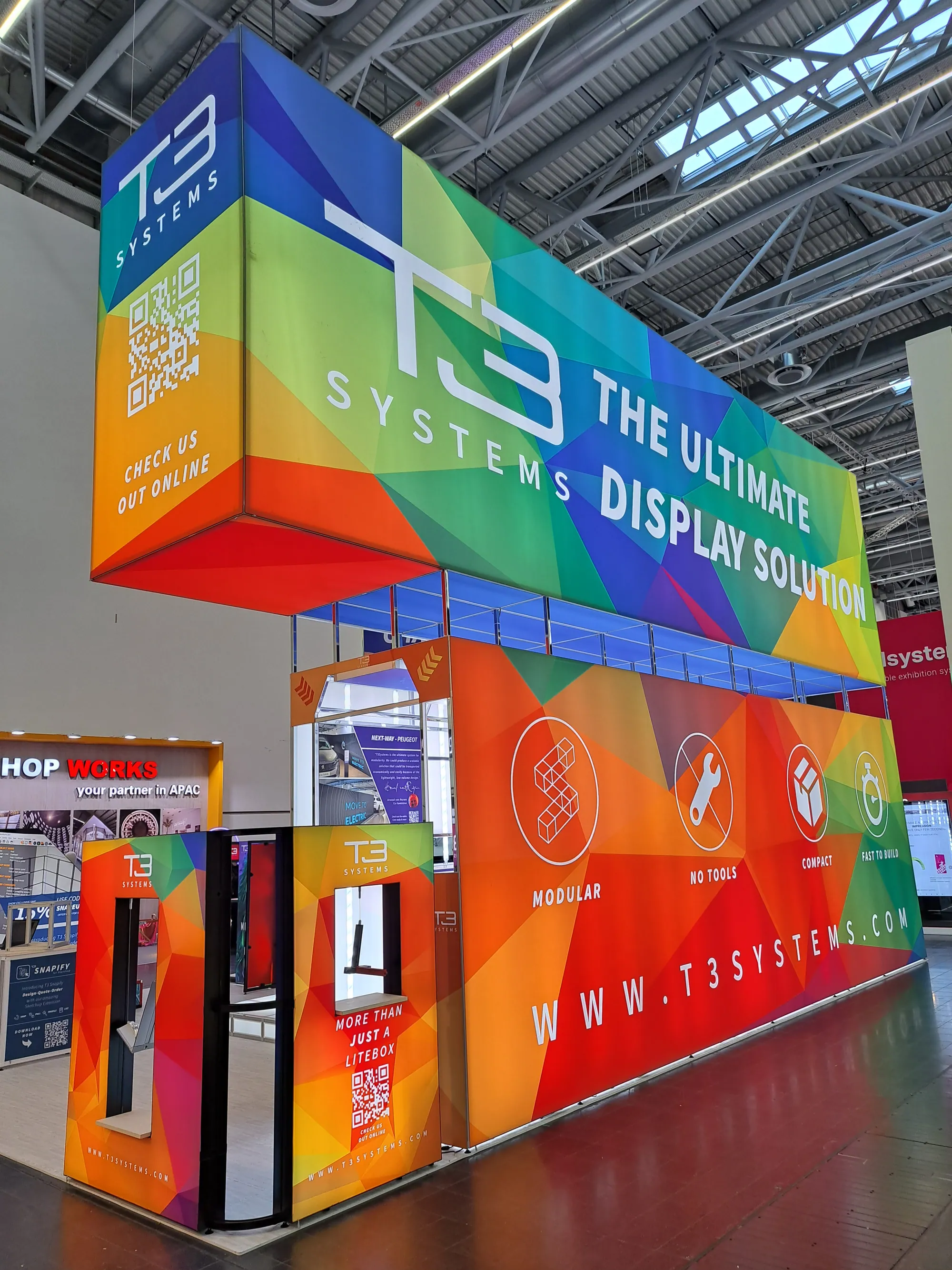 T3 exhibition stand with overhead lightbox header and colourful graphics