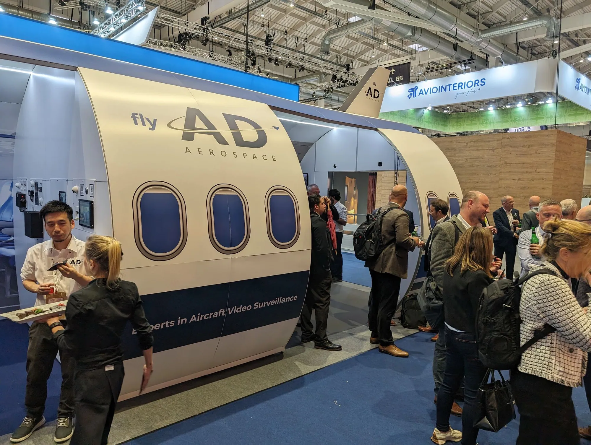 Visitors at an aircraft fuselage themed T3 stand at an aerospace exhibition
