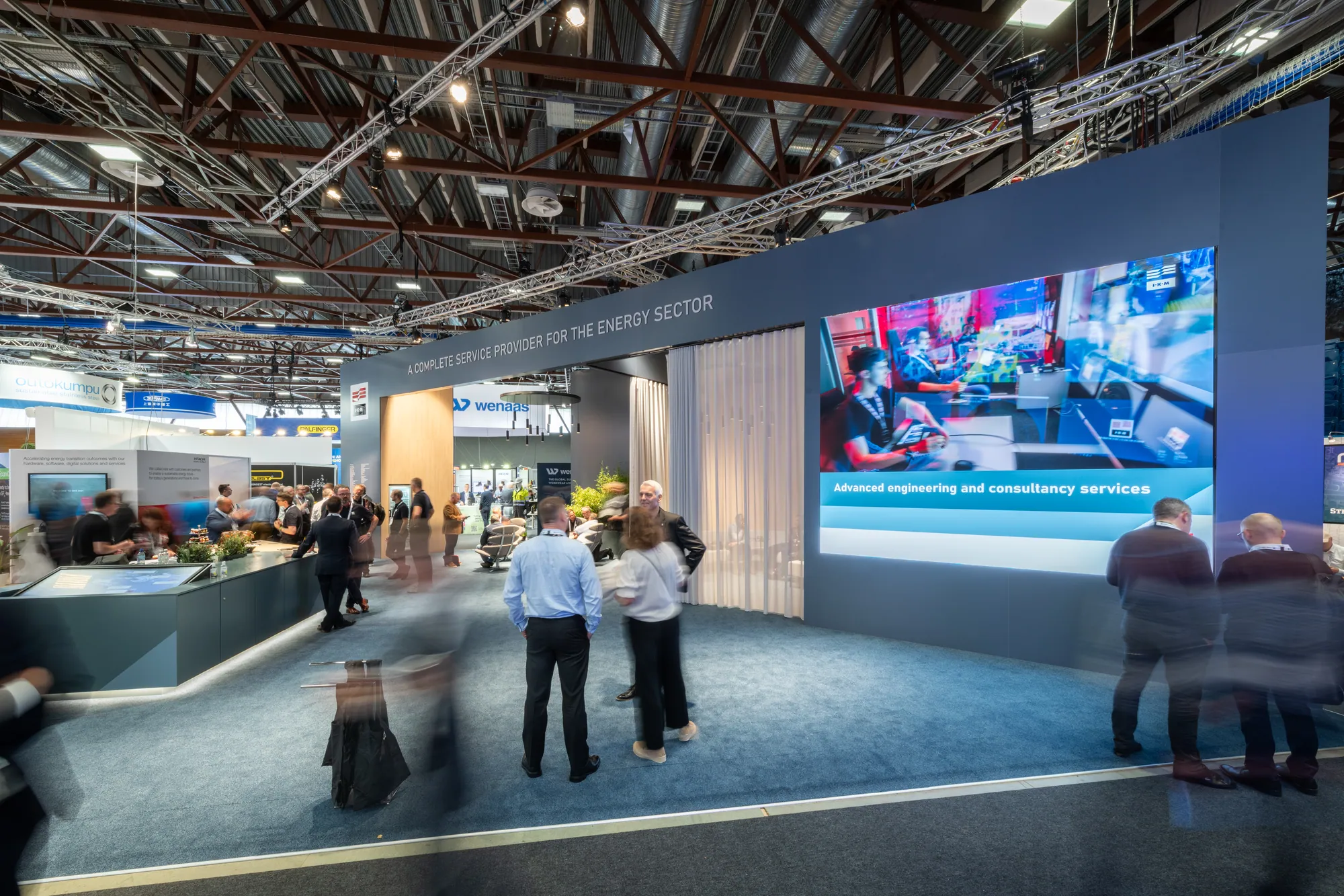 Large energy sector custom stand with LED screen wall and hospitality bar