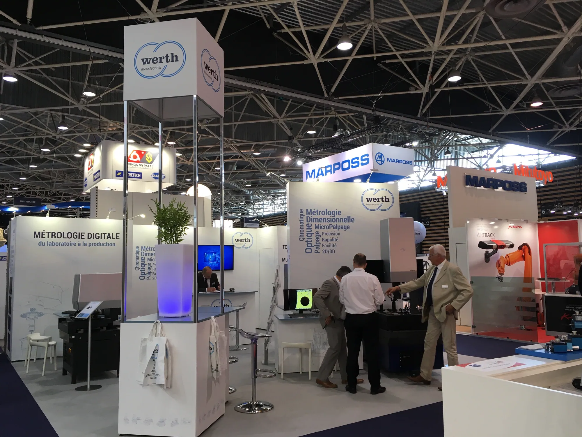 Exhibition stand with branded towers and product demonstration area