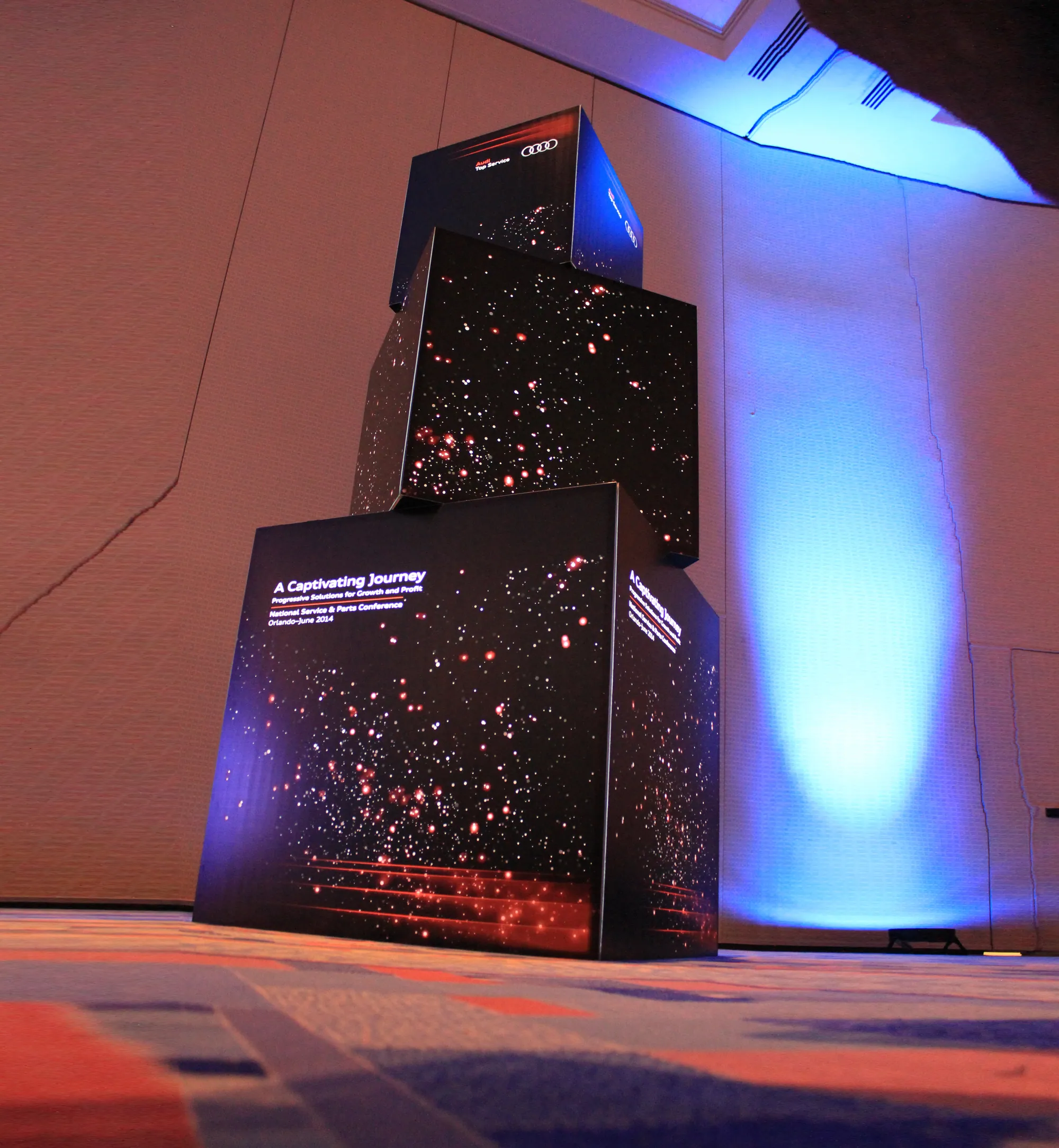 Stacked black illuminated cubes built with T3 for a brand experience