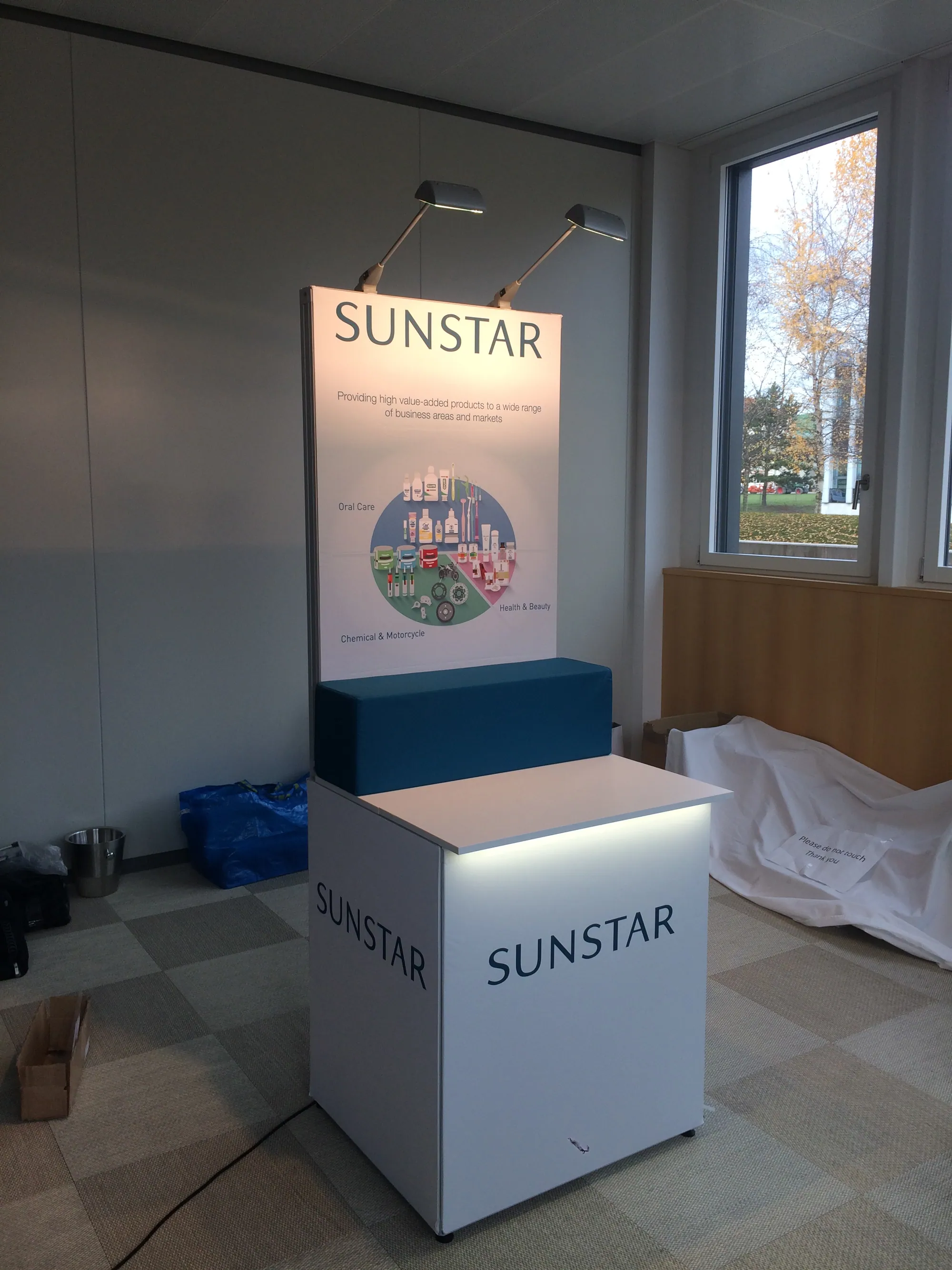 Branded plinth with header panel and spotlights built with T3