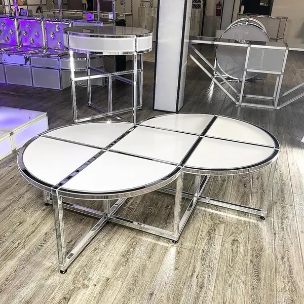 Round chrome-frame coffee tables with white inset tops built with T3