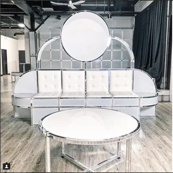 White lounge sofa with circular backdrop and round coffee table built with T3