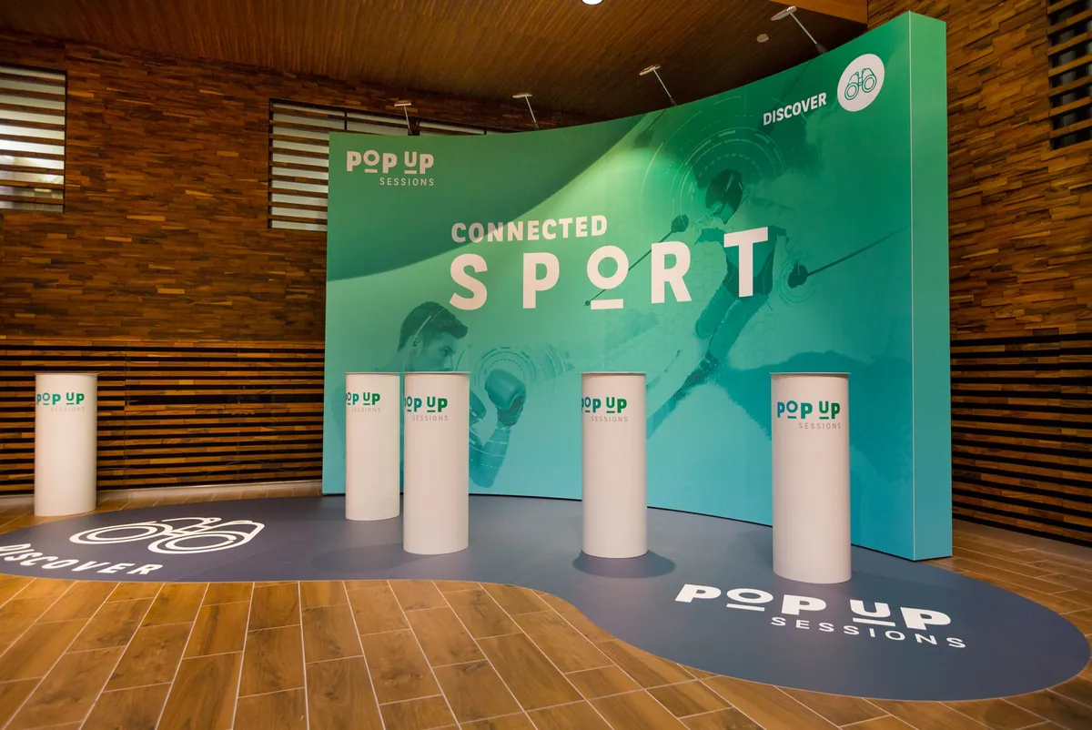 Curved fabric backdrop with display plinths and floor graphic