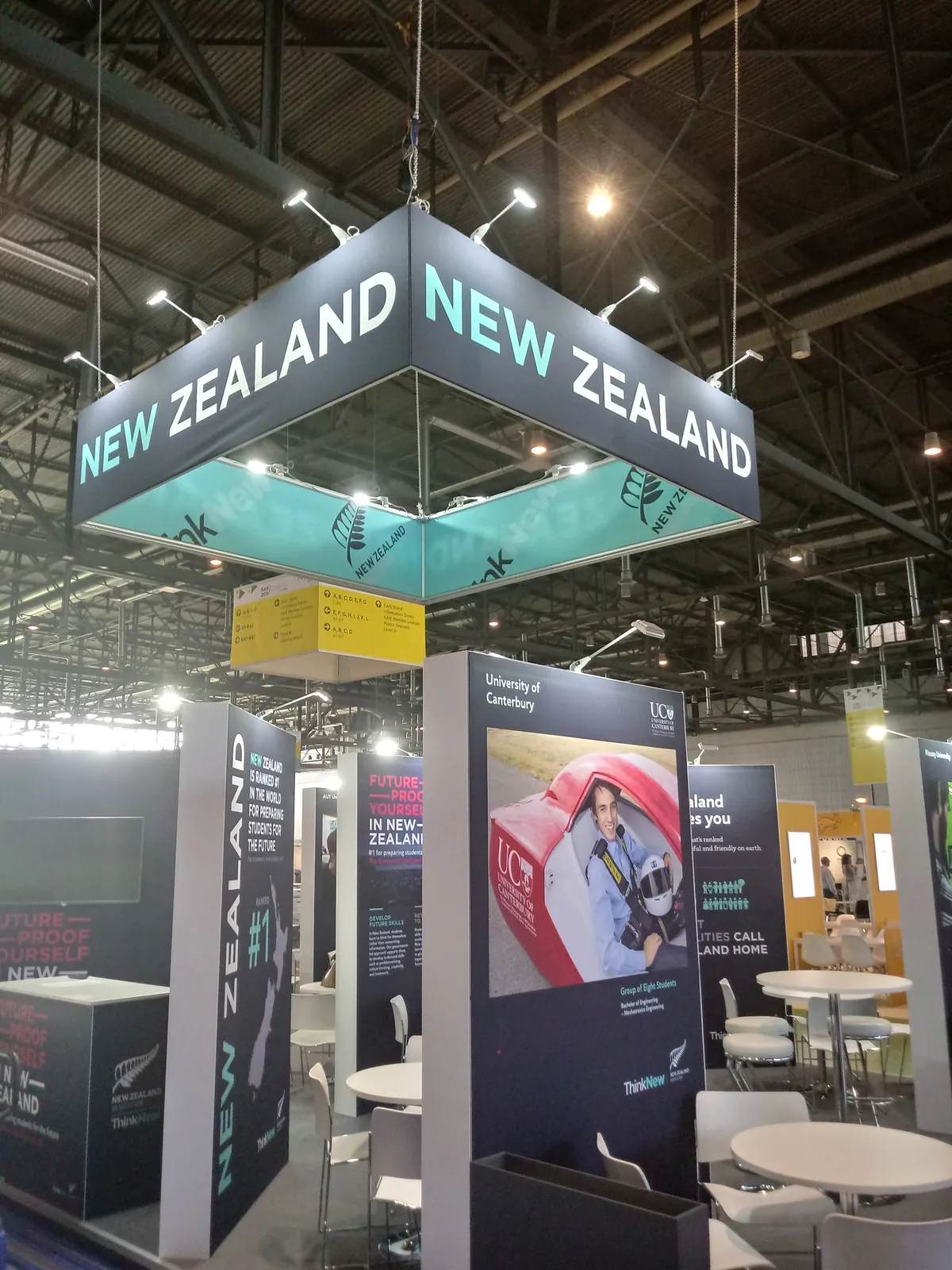 Hanging banner sign above a national pavilion built with T3
