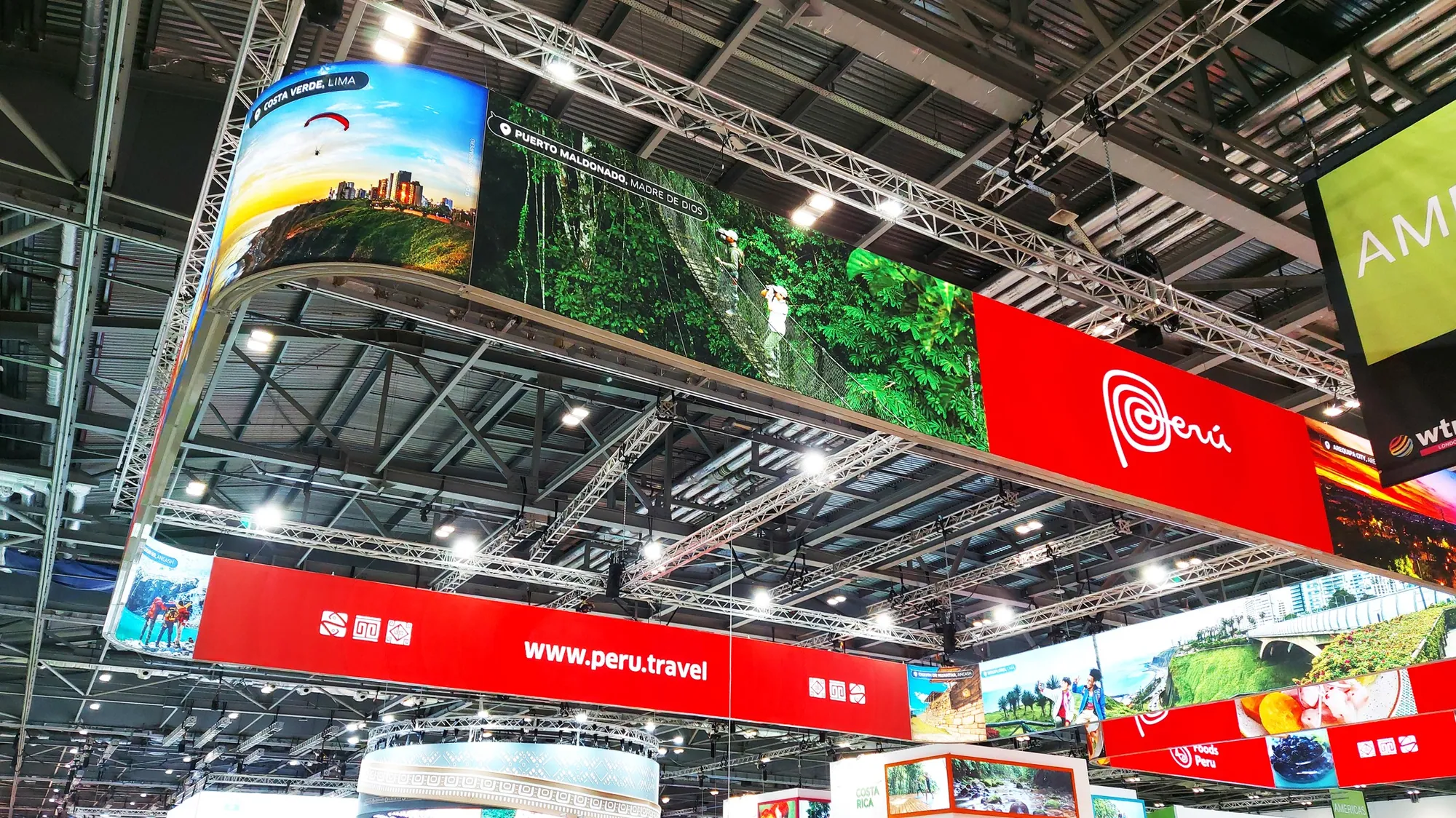 Suspended banner structures above a large travel trade show pavilion