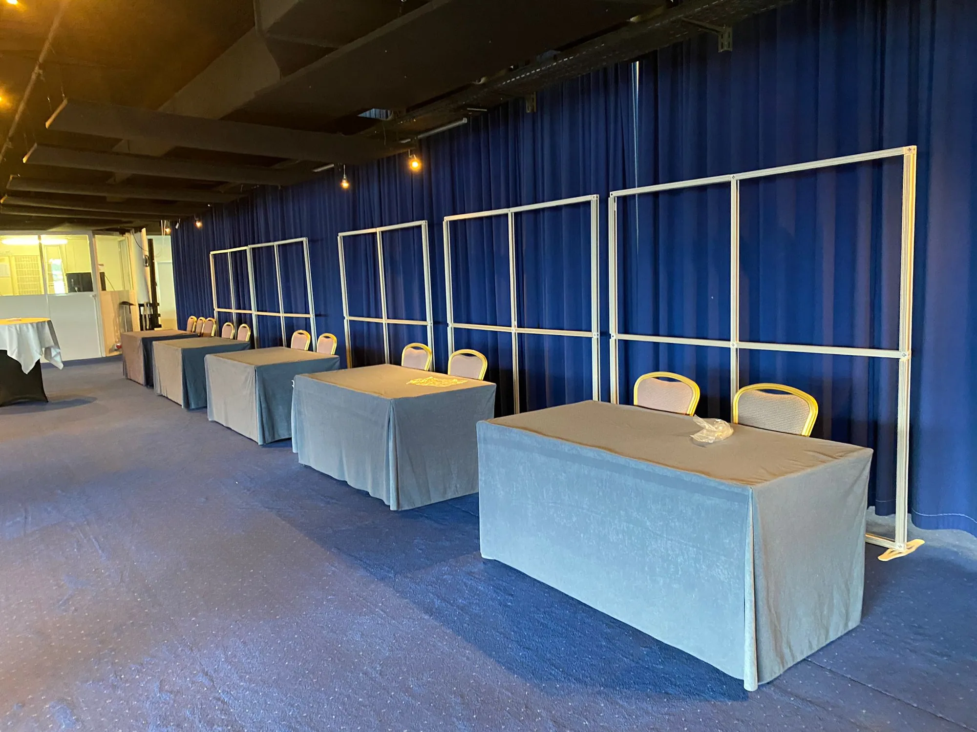 Unclad T3 frames forming a row of conference meeting booths before graphics are fitted