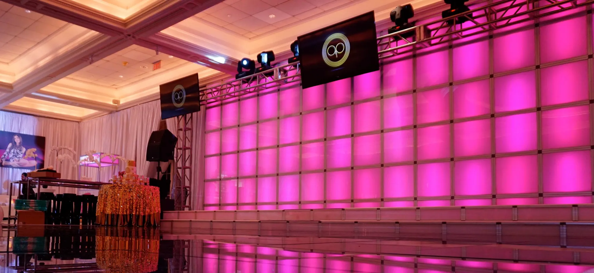 Pink-lit T3 lightbox feature wall in an event ballroom
